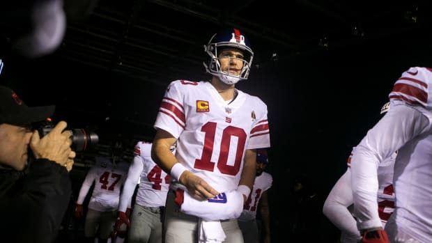 New York's Eli Manning walks out of the tunnel Monday night against the Eagles. The Eagles defeated the Giants in overtime 23-17. Sports Eagles Giants